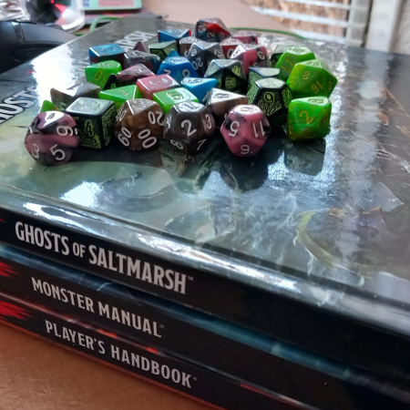 A page image of three DnD 5e books: Player's Handbook, Monster Manual, and Ghosts of Saltmarsh, topped with DnD 5e dice